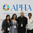 four people in front of APHA logo