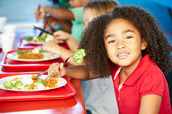 smiling girl with school lunch tray