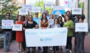 APHA staff holding March for Science signs