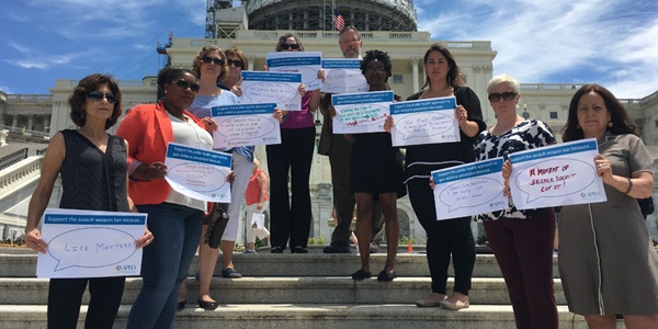 people on Capitol steps holding gun violence prevention signs