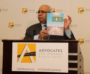Georges Benjamin holding up traffic safety report