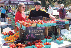 Shoppers browse for tomatoes at the City of Falls Church, Virginia, Farmers Market