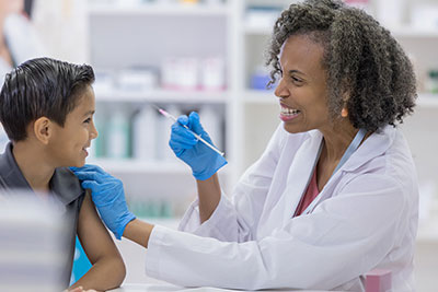 Doctor administering vaccine to child