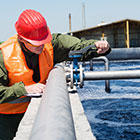 Worker adjusting water pipe