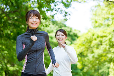 Two smiling women jogging