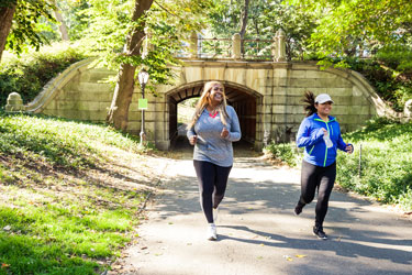 Two people running in a park