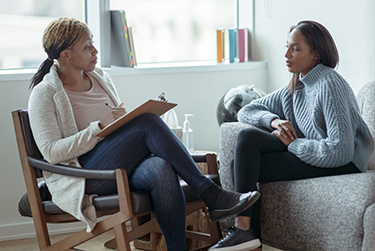 Woman receives counseling from a therapist.