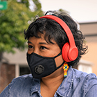 Close-up of a Filipinx woman with a filtering face mask.