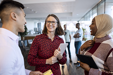 Diverse workers happily chat together