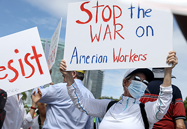 People take to the streets in protest of the firing of federal workers