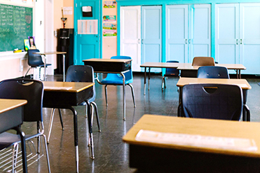 Desks in a classroom with no students