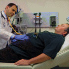 doctor examining man on hospital bed