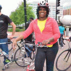 smiling woman standing next to bike