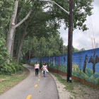 two people walking on paved trail