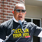 Marc Morial speaks at an event while wearing a shirt saying, "Reclaim Your Vote"